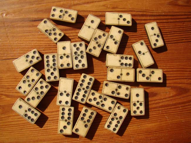 A set of 26 antique 19th century bone and ebony dominoes